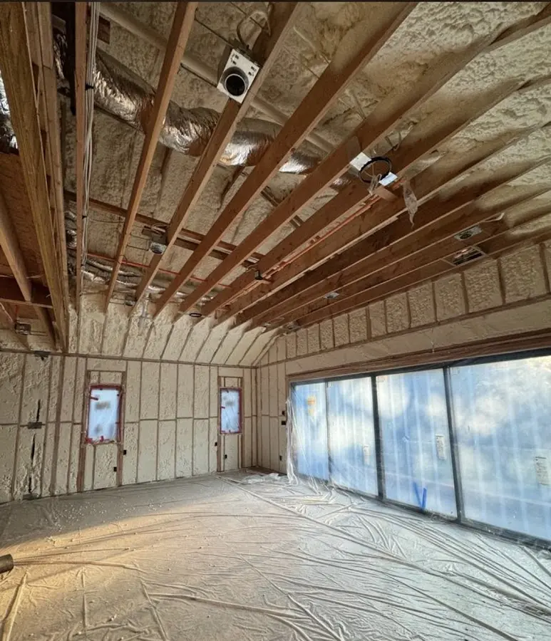 Interior walls and ceiling insulated with spray foam during new construction in Owosso